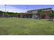 Exterior view of recreation complex with brick facade, palm trees, and green lawn, a community gathering place at 486 Maple Oak Ln, Charleston, SC 29414