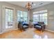 Cozy sun room with lots of natural light, light wood floors and comfortable chairs at 486 Maple Oak Ln, Charleston, SC 29414