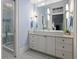 Bathroom featuring double vanity, tile flooring, and glass-enclosed shower with white fixtures at 5 Logan St, Charleston, SC 29401