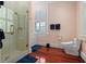Bathroom featuring a walk-in shower with marbled tile, toilet and natural light at 5 Logan St, Charleston, SC 29401