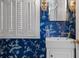 Stylish powder room with designer wallpaper, sink, and shuttered window, highlighting the unique aesthetic at 5 Logan St, Charleston, SC 29401