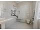 Bathroom featuring a walk-in shower with marble tile, toilet and classic pedestal sink at 5 Logan St, Charleston, SC 29401