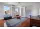 Bright bedroom with built-in bookshelves, natural light, hardwood floors, and area rug at 5 Logan St, Charleston, SC 29401