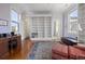 Bright bedroom featuring hardwood floors, a decorative rug, and custom built-in shelving at 5 Logan St, Charleston, SC 29401