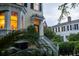 Charming house exterior with bay window, a stained glass front door, and a manicured front garden at 5 Logan St, Charleston, SC 29401