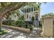 Well-maintained yellow home with a bay window, front porch, and black iron fence at 5 Logan St, Charleston, SC 29401