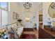 Welcoming foyer with a stained-glass door, hardwood floors, and elegant furnishings at 5 Logan St, Charleston, SC 29401