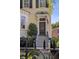 Inviting home featuring a stained glass front door, black shutters, and a well-manicured lawn and garden at 5 Logan St, Charleston, SC 29401