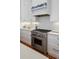 A stainless steel range with white cabinetry and drawers under marble countertops complete this kitchen at 5 Logan St, Charleston, SC 29401