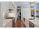 Modern kitchen with white cabinets and a view into the foyer at 5 Logan St, Charleston, SC 29401