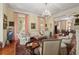 Formal living room with chandelier, neutral furniture, and adjacent formal dining at 5 Logan St, Charleston, SC 29401