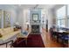 Comfortable living room with fireplace, hardwood floors, and a view into the kitchen at 5 Logan St, Charleston, SC 29401