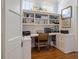 Bright home office featuring built-in bookshelves and cabinetry, creating a functional and stylish workspace at 5 Logan St, Charleston, SC 29401