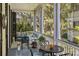 Relaxing outdoor space with comfortable seating, ceiling fans, and a charming neighborhood view at 5 Logan St, Charleston, SC 29401