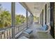 Wide front porch with wicker furniture and charming architectural details at 5 Logan St, Charleston, SC 29401