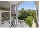Inviting screened porch with white railings offering scenic views of the landscaped yard at 5 Logan St, Charleston, SC 29401