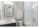 Modern bathroom with glass shower, white subway tiles, and a dark vanity at 504 Marsh Cove Cir, Summerville, SC 29486
