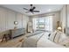 Spacious main bedroom features wainscoting, a ceiling fan, and a large window at 504 Marsh Cove Cir, Summerville, SC 29486