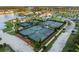 Aerial view of tennis courts with manicured landscaping, and neighborhood lake in the background at 504 Marsh Cove Cir, Summerville, SC 29486