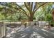 Charming backyard deck with seating area offering serene views of the lush landscaping and large trees at 5126 Highway 174, Hollywood, SC 29449