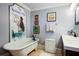 Bathroom with clawfoot tub and charming mermaid-themed decor and a modern sink at 5126 Highway 174, Hollywood, SC 29449
