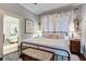 Charming bedroom with wood paneling, iron bed frame, and whimsical mermaid-themed bathroom access at 5126 Highway 174, Hollywood, SC 29449