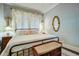 Cozy bedroom featuring wood paneling, a wrought iron bed, and soft, ambient lighting at 5126 Highway 174, Hollywood, SC 29449