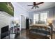 Cozy bedroom featuring hardwood floors, a ceiling fan, a brick fireplace and ample natural light at 5126 Highway 174, Hollywood, SC 29449