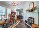 Charming dining area features hardwood floors, classic fireplace, and seamless flow at 5126 Highway 174, Hollywood, SC 29449