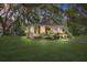 Charming home with inviting porch, American flag, and lush lawn, showcasing curb appeal at 5126 Highway 174, Hollywood, SC 29449