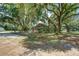 Quaint home surrounded by lush greenery, featuring a spacious yard and mature trees at 5126 Highway 174, Hollywood, SC 29449