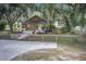 Charming exterior of home with mature trees, fenced yard and private driveway at 5126 Highway 174, Hollywood, SC 29449