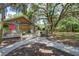 Quaint home with inviting front porch and beautifully landscaped yard shaded by mature trees at 5126 Highway 174, Hollywood, SC 29449