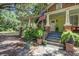 Charming porch features beautiful plants, brick columns, and a welcoming entrance at 5126 Highway 174, Hollywood, SC 29449