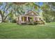 Inviting home with lush lawn, mature trees, and quaint porch, perfect for relaxation at 5126 Highway 174, Hollywood, SC 29449