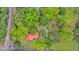 Aerial view of property with a red roofed home nestled among lush trees, near railway at 516 Hope Plantation Ln, Jacksonboro, SC 29452