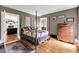 Bedroom with hardwood floors, 4 poster bed, and connected living area at 516 Hope Plantation Ln, Jacksonboro, SC 29452