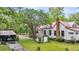 Charming home with a red roof and a well-maintained lawn, featuring a garage and mature trees at 516 Hope Plantation Ln, Jacksonboro, SC 29452