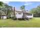Charming home with a red roof, inviting front porch, and lush landscaping in a serene setting at 516 Hope Plantation Ln, Jacksonboro, SC 29452