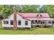 Quaint farmhouse with a red roof, white siding, and a welcoming front porch at 516 Hope Plantation Ln, Jacksonboro, SC 29452