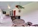 Charming front porch with seating, decorative fish art, compass rose, and a painted ceiling at 516 Hope Plantation Ln, Jacksonboro, SC 29452