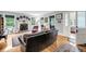 Comfortable living room boasts hardwood floors, a fireplace, large windows, and vintage furnishings at 516 Hope Plantation Ln, Jacksonboro, SC 29452