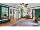 Open-concept living room features hardwood floors, and large windows at 516 Hope Plantation Ln, Jacksonboro, SC 29452