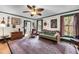 Cozy living room featuring hardwood floors, a ceiling fan, vintage decor, and natural light from the window at 516 Hope Plantation Ln, Jacksonboro, SC 29452