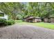 Outbuildings offer functional space on the property, set amidst mature trees at 516 Hope Plantation Ln, Jacksonboro, SC 29452