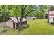 Rustic shed nestled under a large tree, adding character to the property's landscape at 516 Hope Plantation Ln, Jacksonboro, SC 29452