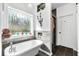 Modern bathroom featuring a soaking tub, decorative window, and stylish finishes at 555 Pointe Of Oaks Rd, Summerville, SC 29485