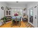 Cozy breakfast nook filled with plants and vintage furniture, natural light streaming through the window at 555 Pointe Of Oaks Rd, Summerville, SC 29485