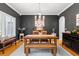 Stylish dining room with a light wood table, chandelier, and ample seating, perfect for Gathering meals and gatherings at 555 Pointe Of Oaks Rd, Summerville, SC 29485