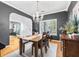 Well-appointed dining room featuring a wood table, chandelier, and ample natural light from large windows, great for gatherings at 555 Pointe Of Oaks Rd, Summerville, SC 29485
